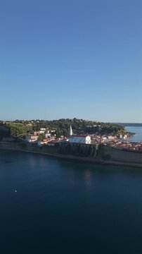 Aerial view of Piran coastal old town and Saint George parish church on cliff above Adriatic sea in Slovenia