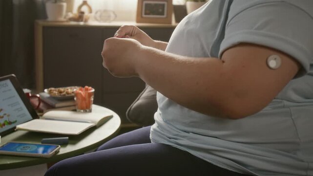 Unrecognizable woman injecting insulin into belly using medical pen at home. Clip suits diabetes care campaigns, endocrinology educational content, and pharmaceutical marketing