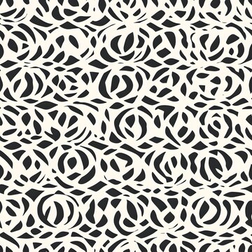 Black and white abstract cutout pattern with floral motif