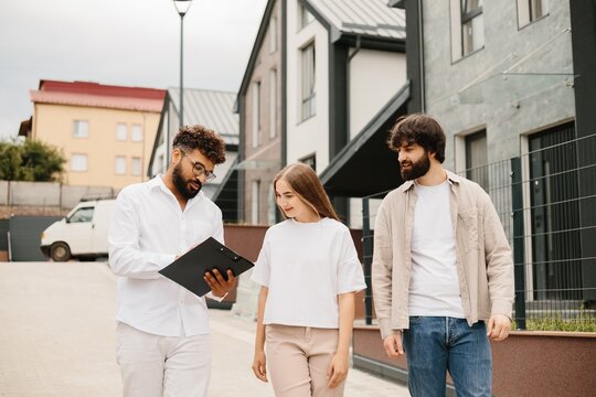 Realtor discussing new home documents with couple