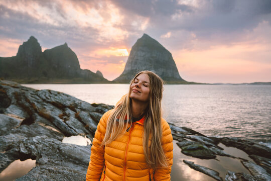 Woman explorer travel solo in Norway female tourist enjoying sunset Traena islands view, active summer vacation retreat adventure lifestyle tour explore Helgeland outdoor happiness harmony with nature