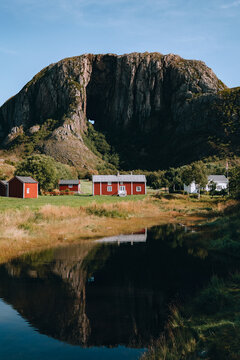 Scenic Torghatten landmark in Norway famous for natural tunnel through rocky mountain, Helgeland landscape with wooden houses and lake summer countryside Scandinavian travel destination