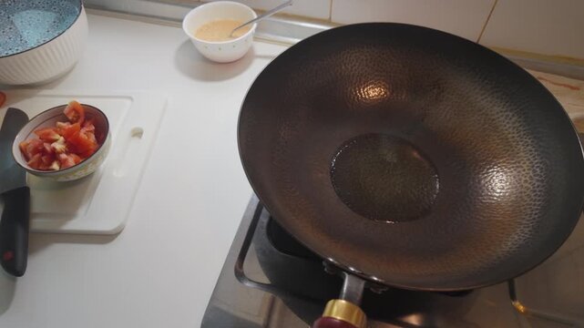 Pouring Cooking Oil into a Hot Traditional Iron Wok