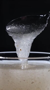 Textured psyllium husk gel forming in water under studio high contrast lighting