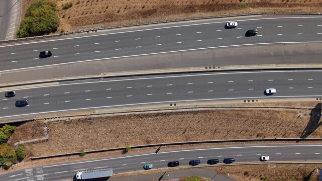 Top down aerial hyperlapse of busy traffic moving along the A1 motorway junction in the UK