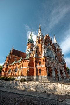 Krakow, Poland - July 18, 2026: Low-angle side view of the red-brick Neo-Gothic St. Joseph&rsquo;s Church in Podgorze.