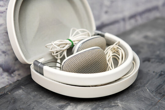 Bowers & Wilkins P3 headphones fold inside an open protective case with their cable.
