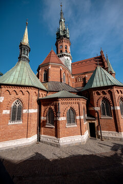 Krakow, Poland - July 18, 2026: Low-angle side view of the red-brick Neo-Gothic St. Joseph&rsquo;s Church in Podgorze.