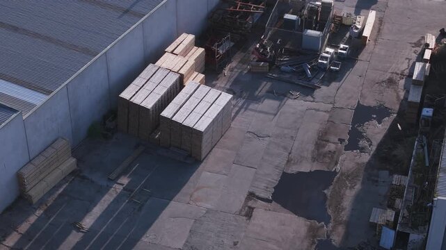 Aerial view of moving shadows in an industrial backyard