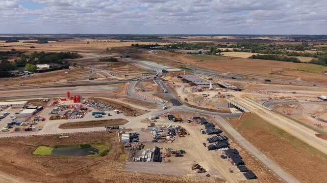 Aerial view of major highway construction site with new bridge structures and earthworks in Bedfordshire, UK