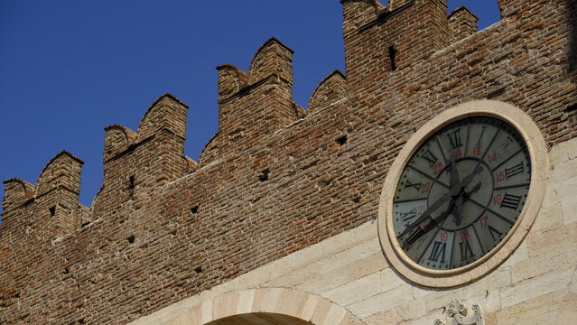Medieval crenellated city walls and historic clock at Piazza Bra, Verona