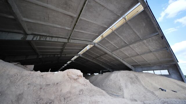 Storing animal feed in a large concrete agricultural hangar for livestock