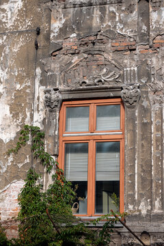 Krakow, Poland - July 18, 2026: Ornately carved stone window surround on a weathered historic building near the Vistula River.