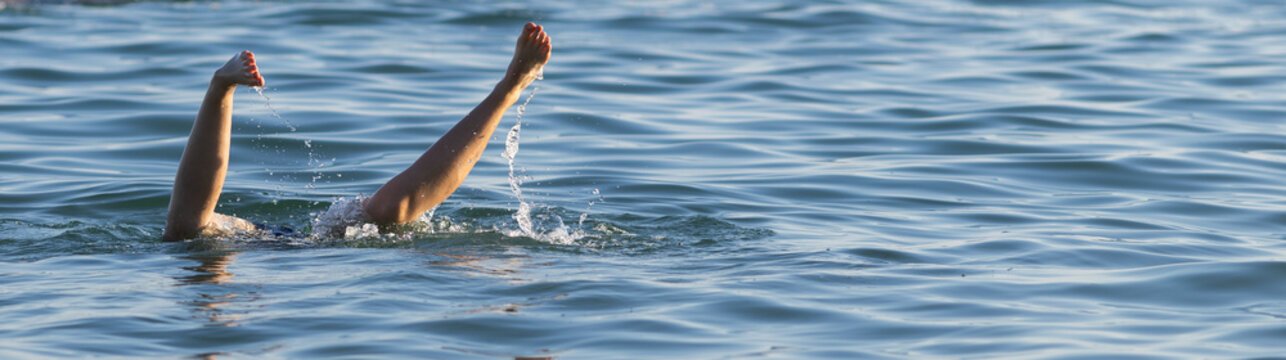 feet of someone diving in the sea