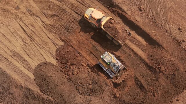 Aerial view of heavy earthmoving machinery moving soil spoil during major highway construction in Bedfordshire, UK