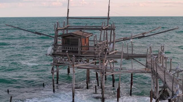 Trabocco Turchino San Vito Chietino Costa dei Trabocchi Abruzzo Italy 70mm drone seagulls perched long wooden pier crashing waves seagulls ambient nature sea sound 4k 