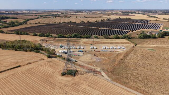 Aerial view of co-located photovoltaic solar farm array and battery energy storage system in Eaton Socon, UK