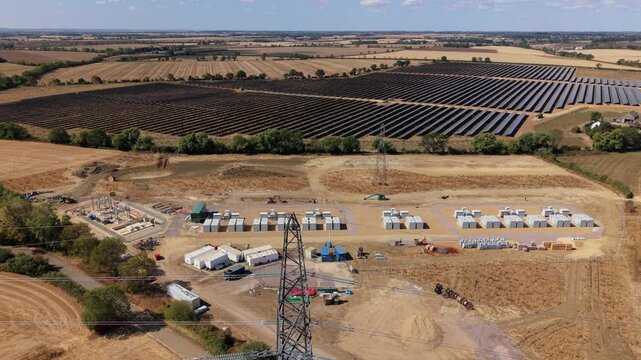 Aerial view of co-located photovoltaic solar farm array and battery energy storage system in Eaton Socon, UK