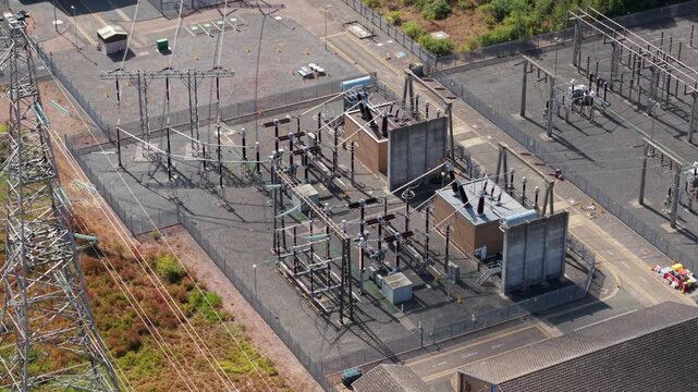 Close-up aerial view of high voltage step-down transformers and electrical switchgear in Eaton Socon, UK