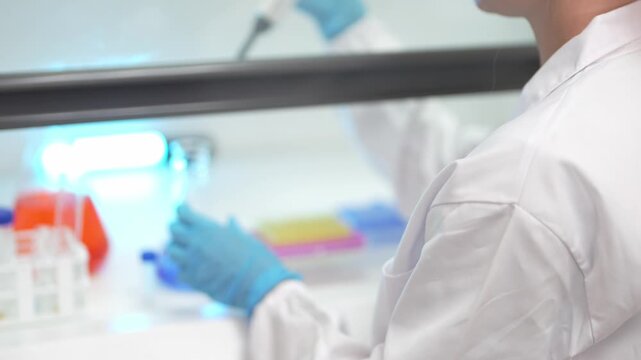 Scientist conducting chemical analysis with a pipette in a modern sterile laboratory setting