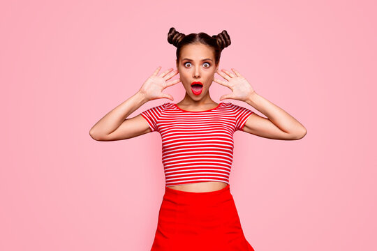 Portrait of young gorgeous and shocked girl with brown eyes and red lipstick on the mouse look at the camera with her fingers spread wide. Concept of advertising isolated on red background