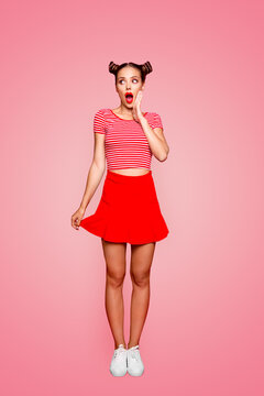 Full-length body vertical portrait of crazy lovely joyful girl with open red mouth, shocked by great news isolated on red background