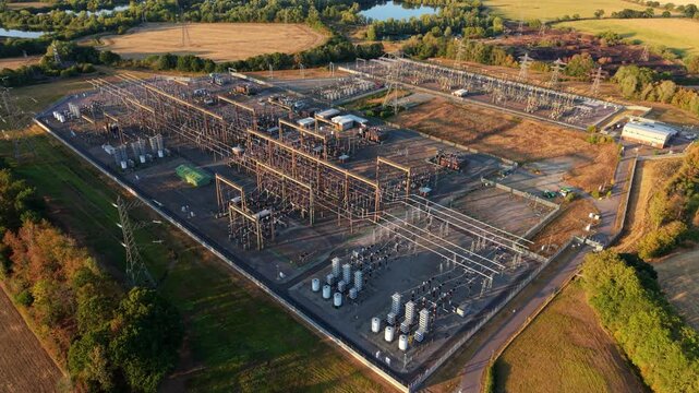 Aerial view of a major 400kV electrical transmission substation and transformer yard in Northamptonshire, UK
