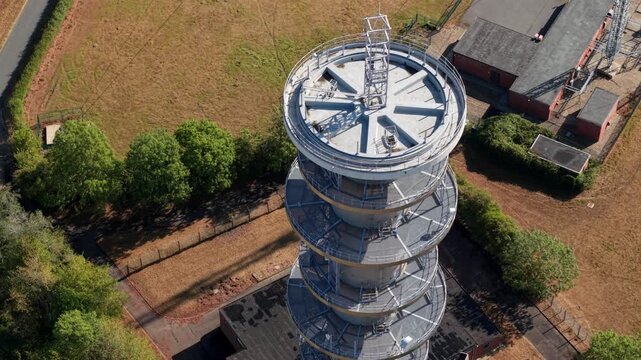 Close-up aerial view of radio communications transmitter tower and antenna arrays near Peterborough, UK