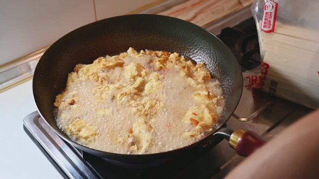 Boiling Tomato and Egg Soup in a Traditional Iron Wok