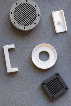 Assorted 3D Printed Prototype Parts on Grey Background