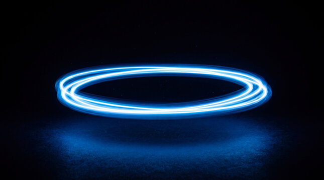 Floating luminous blue light rings glowing in dark empty space creating futuristic circle effect for high tech abstract visual digital motion graphic background.