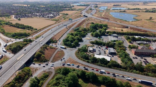 Aerial view of multilane traffic travelling along a major motorway highway in England, UK