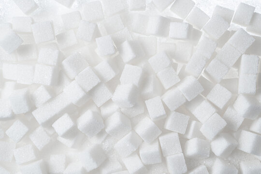 Refined white sugar cubes background texture