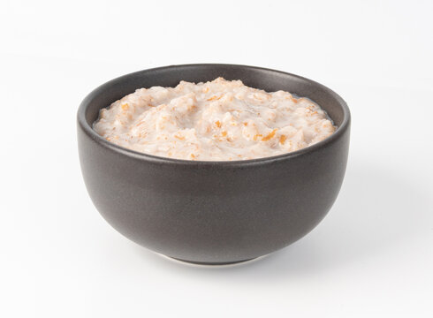 Cooked spelt in bowl. Oatmeal milk porridge, boiled emmer or spelt, healthy cereal food