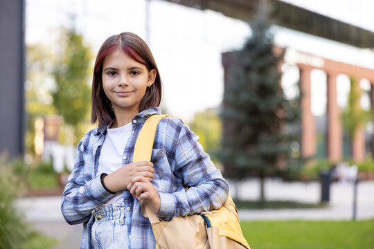 Young student girl standing with backpack ready for school