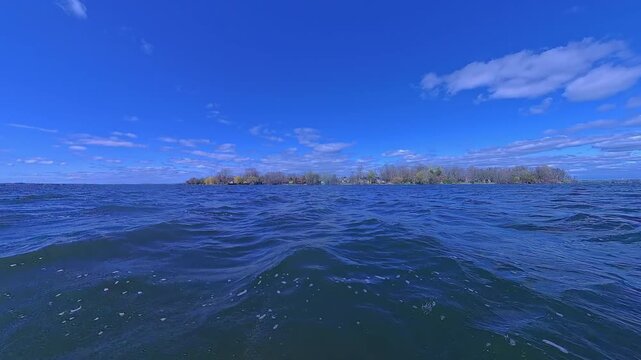 View at passing water while fishing adventure at the lake in Kawartha Lakes Ontario. Peaceful retreat from the busy life routine. Boating at sunny summer day.
