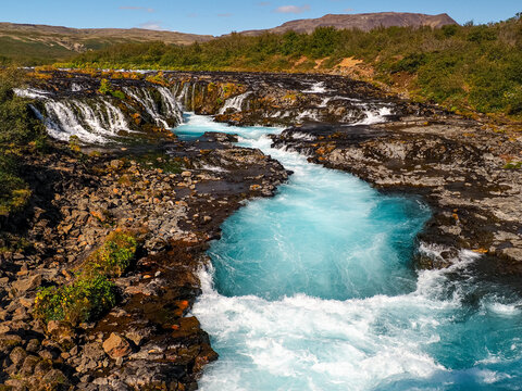 Bruarfoss Waterfall, bright blue water and white splashes. Br&uacute;arfoss means &ldquo;Bridge Falls&rdquo;, name comes from natural stone bridge that once stood over it, making it possible to cross the river. Iceland.