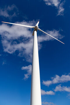 wind turbines against blue sky green energy