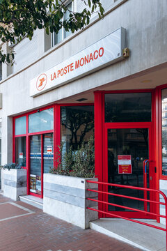 Monaco, Monaco - April 04, 2026: Exterior of a La Poste Monaco post office with red entrance, logo and signage on a city street