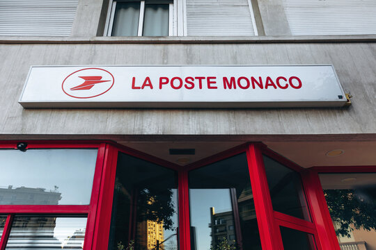 Monaco, Monaco - April 04, 2026: Exterior of a La Poste Monaco post office with red entrance, logo and signage on a city street