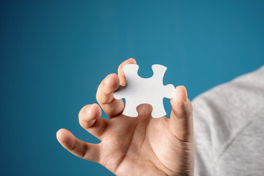 A man holds a puzzle in his hands