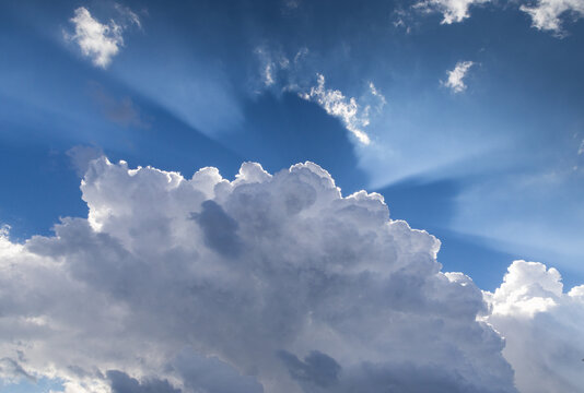 blue sky  white clouds and sunrays