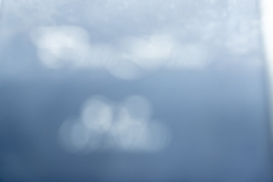 A blurred blue background with white spots, creating a sense of lightness and airiness.