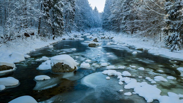 Clear Blue Winter River With Snow Covered Rocks
