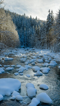 Clear Blue Winter River With Snow Covered Rocks