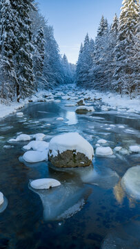 Clear Blue Winter River With Snow Covered Rocks