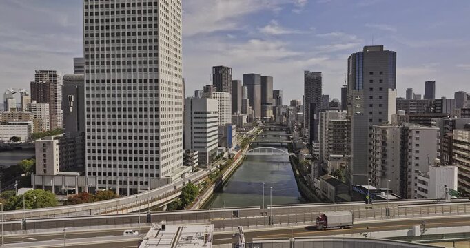 Osaka Japan Aerial v42 low flyover Tosabori river capturing downtown cityscape and bridges connecting Nakanoshima island in Kita ward and Nishi ward - Shot with 5k Camera - Oct 9th 2023