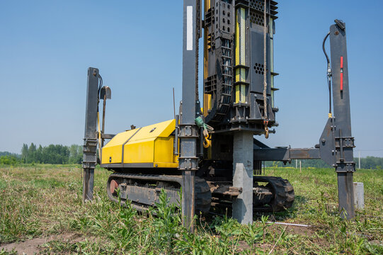 Diesel hammer drives concrete piles for a country house.