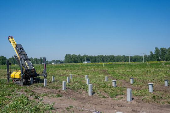 Diesel hammer drives concrete piles for a country house.