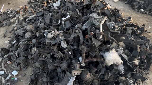 Used Automotive Mounting Brackets and Metal Support Components in Salvage Yard, automotive maintenance, vehicle dismantling, metal recycling, and automobile spare parts industry concepts. 